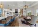 Open-concept kitchen and dining area with an island, barstool seating, and hardwood flooring at 770 Tralee Dr, Fayetteville, GA 30215