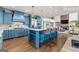 Spacious open-concept kitchen with island seating, hardwood floors, and blue cabinetry at 770 Tralee Dr, Fayetteville, GA 30215