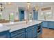 Kitchen island with marble countertops, modern cabinetry, and gold pendant lighting at 770 Tralee Dr, Fayetteville, GA 30215