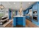 Kitchen with marble counters, stainless appliances, blue cabinetry, and seating at island at 770 Tralee Dr, Fayetteville, GA 30215