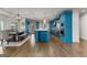 Open concept kitchen with stainless steel appliances, eat in dining area, and blue cabinets at 770 Tralee Dr, Fayetteville, GA 30215