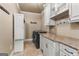 Well-appointed laundry room offers counter space, storage, and modern appliances at 770 Tralee Dr, Fayetteville, GA 30215