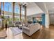 Bright living room with tall windows, hardwood floors, comfortable sofas, and an open layout at 770 Tralee Dr, Fayetteville, GA 30215