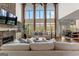 Spacious living room with a stone fireplace, large windows, hardwood floors, and neutral furnishings at 770 Tralee Dr, Fayetteville, GA 30215