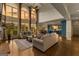 Spacious living room with floor to ceiling windows, hardwood floors, and open to the kitchen at 770 Tralee Dr, Fayetteville, GA 30215