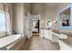 Spacious main bathroom with soaking tub, double vanities, and tile floor at 770 Tralee Dr, Fayetteville, GA 30215