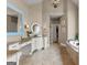 Spacious main bathroom with double vanities, tile floor, and a soaking tub at 770 Tralee Dr, Fayetteville, GA 30215