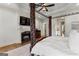 Bright main bedroom features a fireplace, hardwood floors, and a four-poster bed at 770 Tralee Dr, Fayetteville, GA 30215