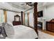 Elegant main bedroom features tray ceilings, a canopy bed, and hardwood floors with a fireplace at 770 Tralee Dr, Fayetteville, GA 30215