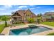Aerial view of a home with a beautiful in-ground pool with a spa and lounge chairs at 770 Tralee Dr, Fayetteville, GA 30215