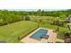 Beautiful pool and patio overlooking a lush green yard with mature landscaping and a golf course at 770 Tralee Dr, Fayetteville, GA 30215