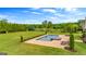 Beautiful pool and patio overlooking a lush green yard with mature landscaping and a golf course at 770 Tralee Dr, Fayetteville, GA 30215