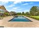 A backyard pool and travertine deck offer a relaxing outdoor retreat with a manicured lawn at 770 Tralee Dr, Fayetteville, GA 30215