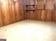 Basement showcasing wood paneling, tiled floors, shelves and a window at 2425 Wood Valley Dr, Morrow, GA 30260