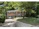 Traditional two-story brick home with green shutters and a mature landscaped front yard at 2425 Wood Valley Dr, Morrow, GA 30260
