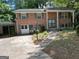 Traditional two-story brick home with green shutters and a mature landscaped front yard at 2425 Wood Valley Dr, Morrow, GA 30260