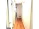Hallway with hardwood floors, white walls and closet doors at 2425 Wood Valley Dr, Morrow, GA 30260