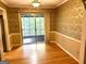 Bright sunroom with classic patterned wallpaper, hardwood floors and a sliding glass door to the backyard at 2425 Wood Valley Dr, Morrow, GA 30260
