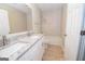Modern bathroom featuring double sinks with granite counters and a tile surround bathtub at 10074 Tara Glynn Dr, Hampton, GA 30228
