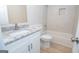 Bathroom featuring a granite sink, tile flooring, and a tub with tile surround at 10074 Tara Glynn Dr, Hampton, GA 30228