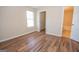 Bright bedroom featuring wood floors, a window, and doorways to a closet and the bathroom at 10074 Tara Glynn Dr, Hampton, GA 30228