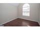 Bright bedroom features a cathedral window and sleek wood flooring at 10074 Tara Glynn Dr, Hampton, GA 30228