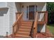 Close up of the front porch stairs that lead to a glass front door, freshly painted steps, landscaping at 10074 Tara Glynn Dr, Hampton, GA 30228