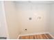 Laundry room with wood-style flooring and hookups for appliances at 10074 Tara Glynn Dr, Hampton, GA 30228