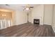Living room, features a fireplace, vaulted ceilings, ceiling fan, and wood-look floors, lots of natural light at 10074 Tara Glynn Dr, Hampton, GA 30228