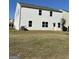 Backyard with a large lawn, a tree, and white siding at 136 Paulownia Cir, Mcdonough, GA 30253
