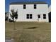Backyard featuring an expansive lawn and white siding at 136 Paulownia Cir, Mcdonough, GA 30253