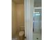 Half bathroom with a toilet and shower, with neutral-colored walls and tile flooring at 136 Paulownia Cir, Mcdonough, GA 30253