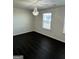 Bedroom with hardwood floors, a chandelier, and a window at 136 Paulownia Cir, Mcdonough, GA 30253