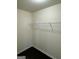 Walk-in closet with wire shelving and dark wood-look floors at 136 Paulownia Cir, Mcdonough, GA 30253