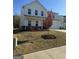 Lovely two-story home showcasing manicured landscaping, charming front porch, and attached two car garage at 136 Paulownia Cir, Mcdonough, GA 30253