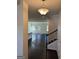 Inviting foyer features dark wood floors, staircase, and an open view to the living area at 136 Paulownia Cir, Mcdonough, GA 30253