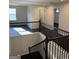 Second floor hallway with black iron railing and lots of light at 136 Paulownia Cir, Mcdonough, GA 30253