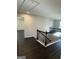 Second floor landing hallway with black iron railing and neutral walls at 136 Paulownia Cir, Mcdonough, GA 30253