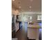 Modern kitchen featuring granite countertops, stainless steel appliances, and open layout at 136 Paulownia Cir, Mcdonough, GA 30253
