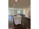 Spacious kitchen island, dark wood floors, recessed lighting, and open concept design at 136 Paulownia Cir, Mcdonough, GA 30253