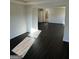 Spacious living room with dark wood-look floors and ample natural light at 136 Paulownia Cir, Mcdonough, GA 30253