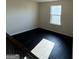 Sunlit loft area with dark hardwood flooring and a window at 136 Paulownia Cir, Mcdonough, GA 30253