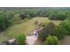 Aerial view of barn, with open acreage and mature trees at 877 Honey Creek Rd, Mcdonough, GA 30252