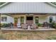 Inviting covered back porch with comfortable seating and an outdoor kitchen area at 877 Honey Creek Rd, Mcdonough, GA 30252