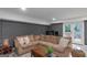 Inviting basement living area features a sectional sofa, wood accents, and exterior access at 877 Honey Creek Rd, Mcdonough, GA 30252
