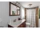Cozy bathroom features a vanity, toilet, and tiled shower with a neutral color scheme at 877 Honey Creek Rd, Mcdonough, GA 30252