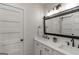 Modern bathroom with dual vanity, white cabinets, and matte black fixtures at 877 Honey Creek Rd, Mcdonough, GA 30252
