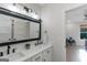 Bright bathroom showcasing a double sink vanity with black hardware and barn door mirror at 877 Honey Creek Rd, Mcdonough, GA 30252