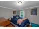 Cozy bedroom with blue bedding, hardwood floors and a bright window view at 877 Honey Creek Rd, Mcdonough, GA 30252