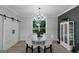 Charming dining room with shiplap wall, modern chandelier, and view of exterior at 877 Honey Creek Rd, Mcdonough, GA 30252